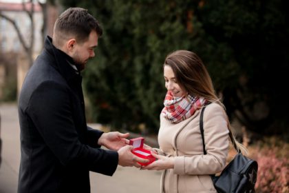 guy gives a girl box with a gift