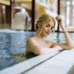 Young woman relaxing in spa swimming pool